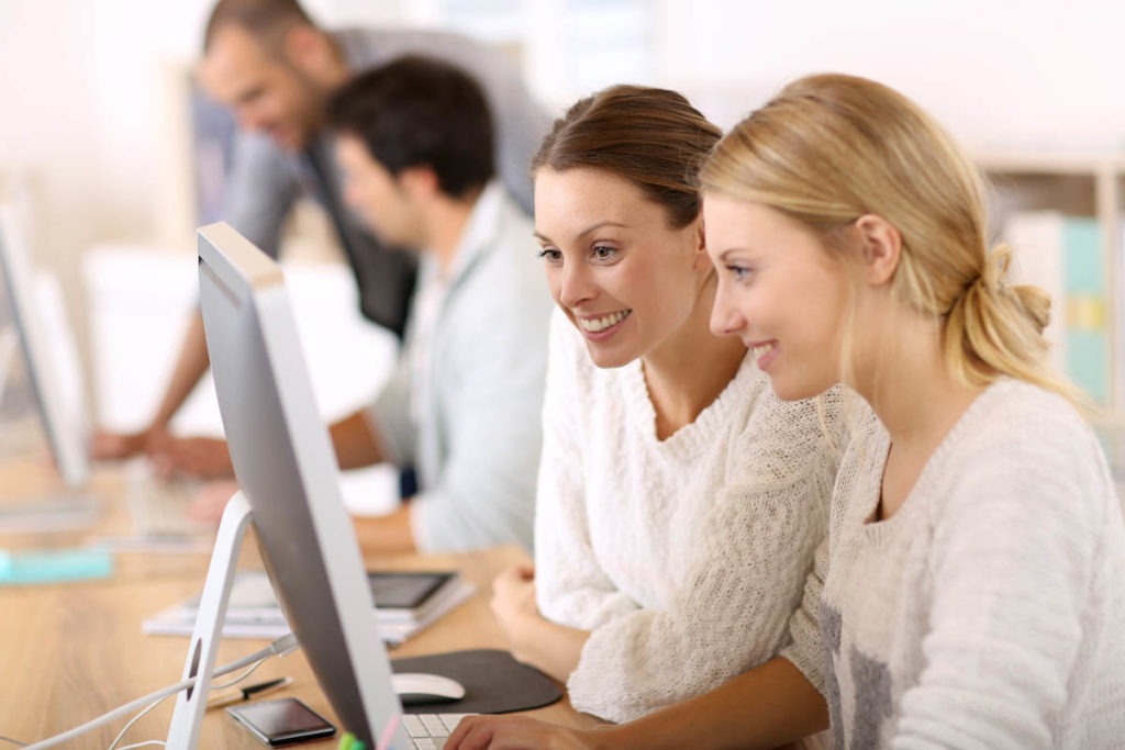 TITAN America's internships opportunities for skill development and youth empowerment: Image of interns working on their computers