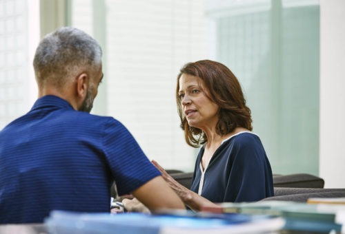 TITAN Usje protecting whistleblowers' rights: image of a woman and a man speaking in confidentiality