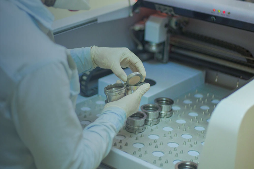 R&D lab, scientist testing cement samples